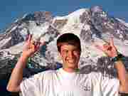 Derek Rowley posing in front of Mt. Rainier.